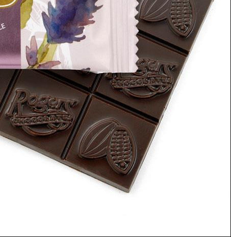 close up of Roger's chocolate bar with lavender flowers on the package on a white background