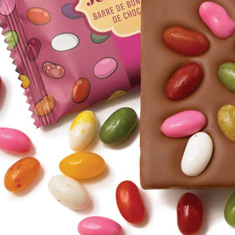 Milk chocolate jelly bean bar with colorful jelly beans on a white background