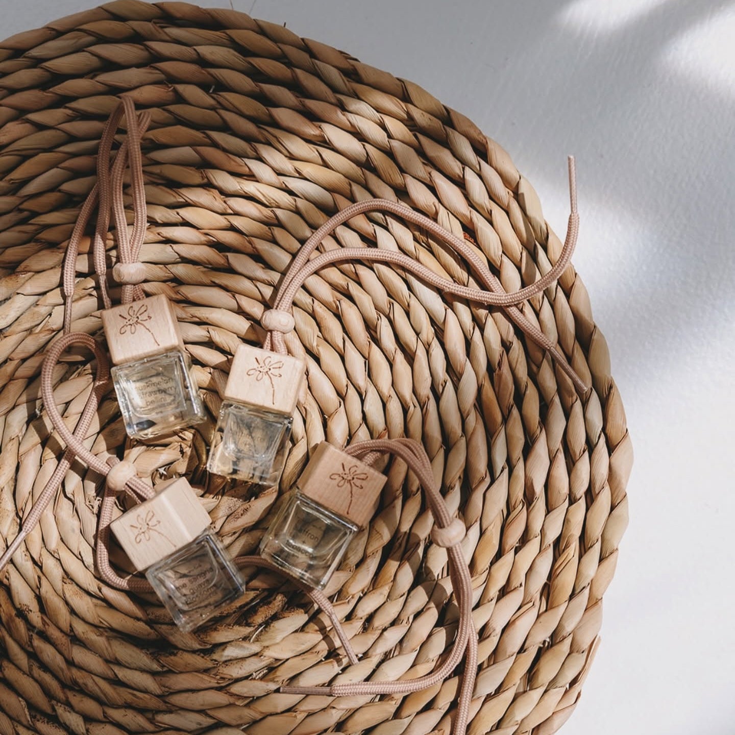 collection of get naked branded car diffuser bottles laying on a woven mat