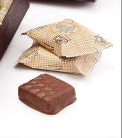Box of Rogers Chocolates with a bow on a white background
