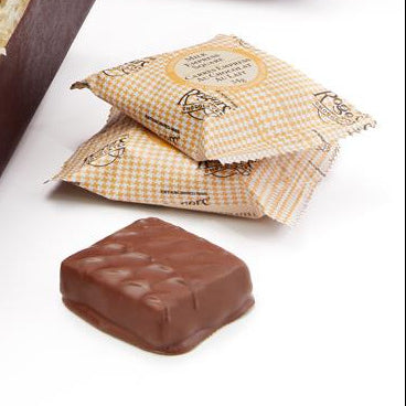 Box of Rogers Chocolates with a bow on a white background