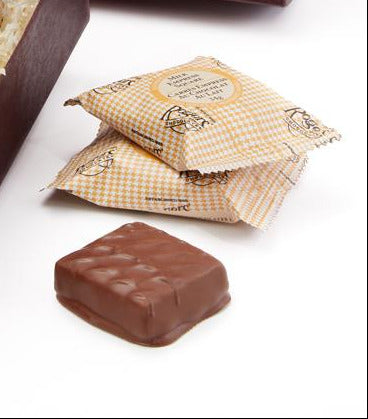 Box of Rogers Chocolates with a bow on a white background