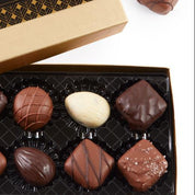 Box of Nuts & Chews chocolate truffles with a decorative label on a white background