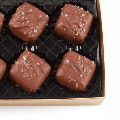 Box of Roger's Empress Squares milk chocolate sea salt candies on a white background