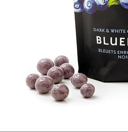 Packaging of Rogers Chocolates dark and white chocolate covered blueberries on a white background