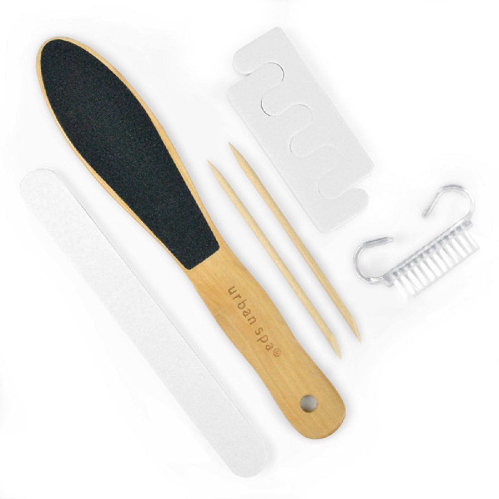 Set of foot care tools including a black stone, wooden file, and brush on a white background.