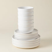 Stack of white ceramic bowls on a beige background