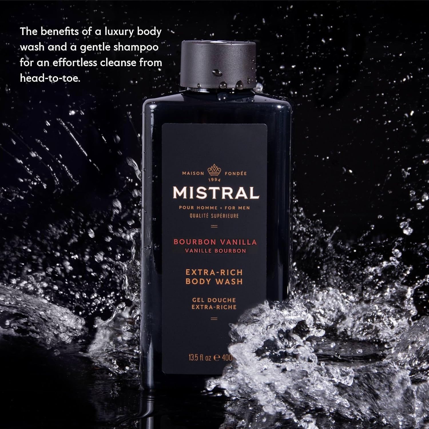 Mistral Golden Tobacco body wash bottle with water splash on a dark background