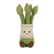 Plush toy bundle of asparagus with a light tan band with a smiling face on a white background