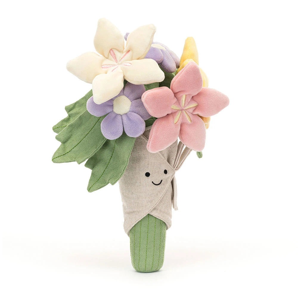 Plush jellycat  bouquet of pink purple white and yellow flowers with a smiling face on a white background