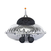 Shiny silver plush space ship with black sparkly smiling face on white background 