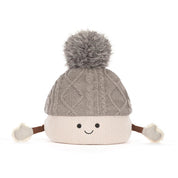 A plush toy toque by jellycat with a gray cable-knit top, a cream ribbed bottom, a gray pom-pom, and small fabric hands and feet, shown on a white background.