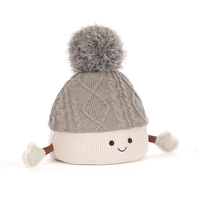A plush toy toque by jellycat with a gray cable-knit top, a cream ribbed bottom, a gray pom-pom, and small fabric hands and feet, shown on a white background.
