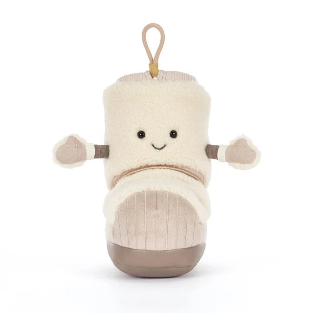 A plush boot-shaped jellycat brand plush toy with a cream sherpa upper, beige corduroy-like lower section, and a tan hanging loop at the top, shown on a plain white background.