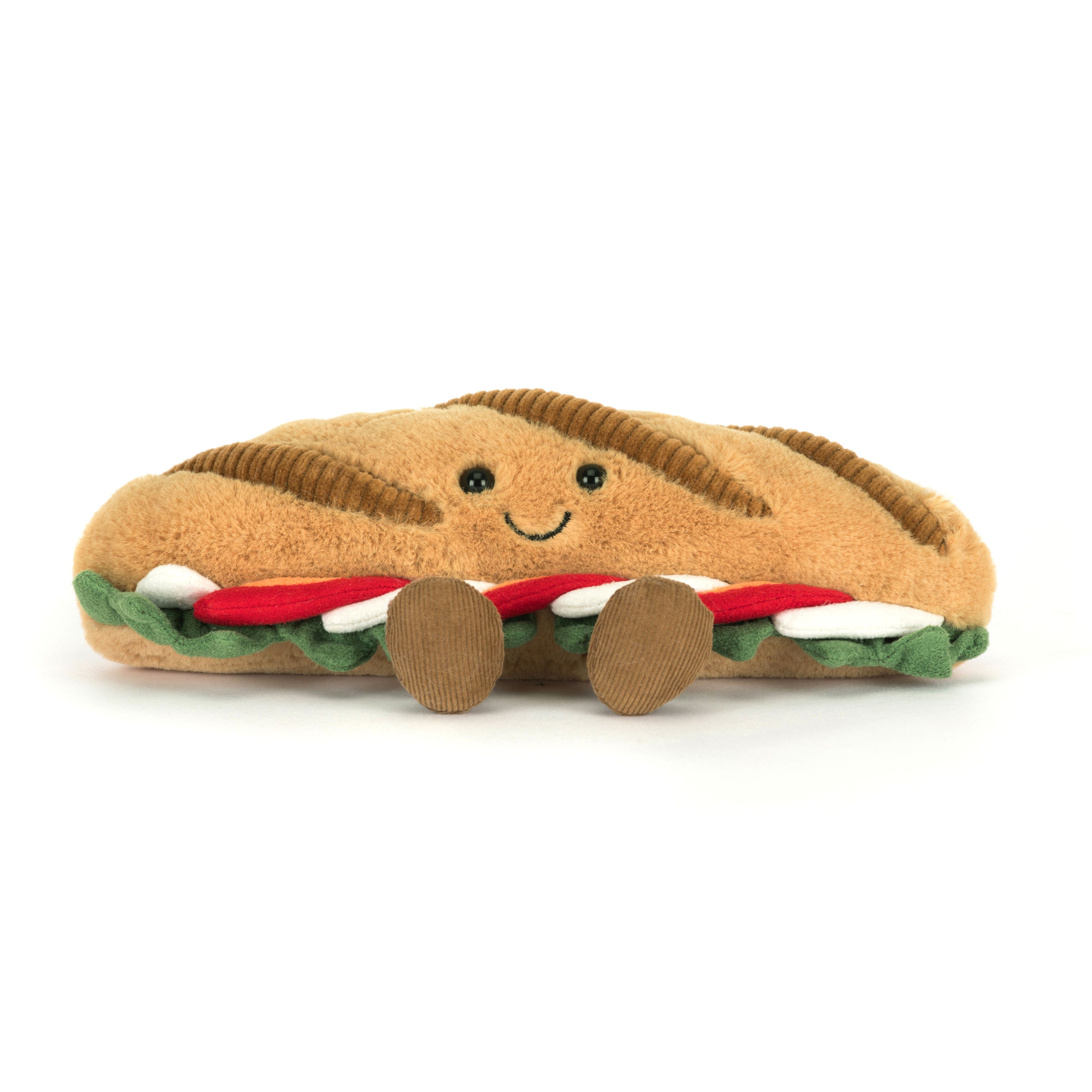 Plush toy shaped like a caprese sandwich with a smiling face on a white background