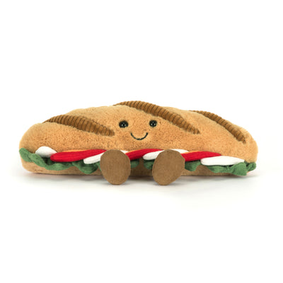 Plush toy shaped like a caprese sandwich with a smiling face on a white background