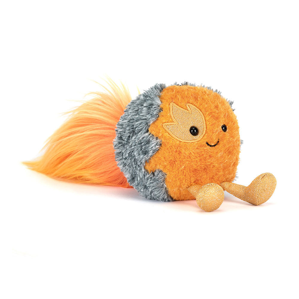 Plush toy space comet with smiling face, orange face, grey stony backside and fluffy orange flaming fur comet tail on a white background