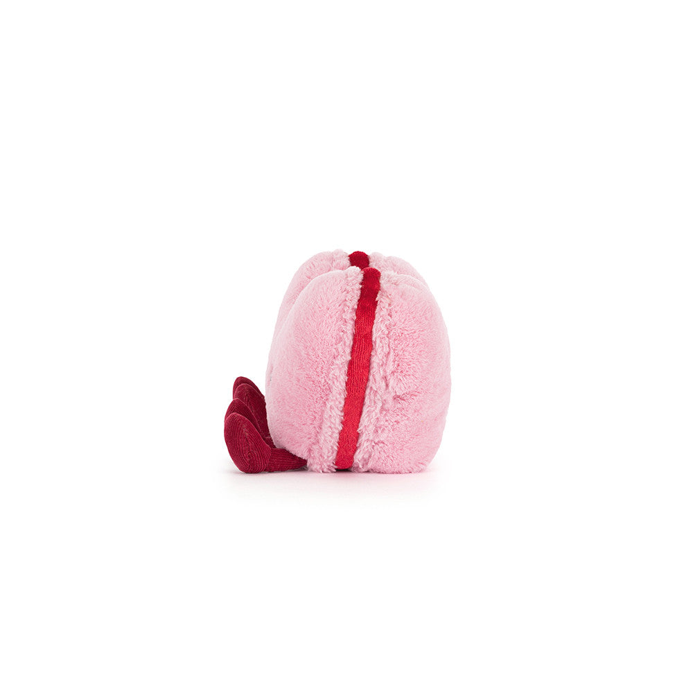 Pink and red plush toy on a white background