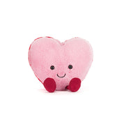 Pink Heart-shaped plush toy macaron with a smiling face on a white background