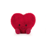 Red heart-shaped macaron plush toy with a smiley face on a white background
