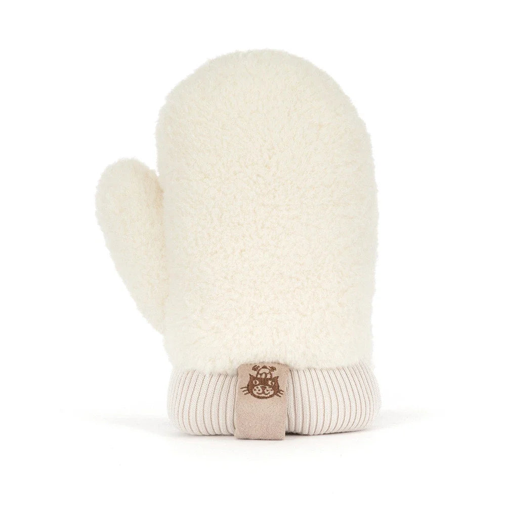 backview of A plush winter mitten jellycat toy in a warm taupe-brown fabric with cream sherpa trim, featuring a simple embroidered smiley face and small feet, shown on a clean white background.