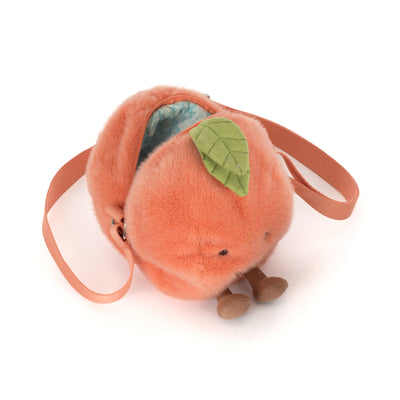 Plush peach-shaped bag with a leaf on a white background