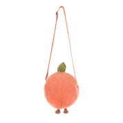 Plush peach-shaped bag with a strap on a white background