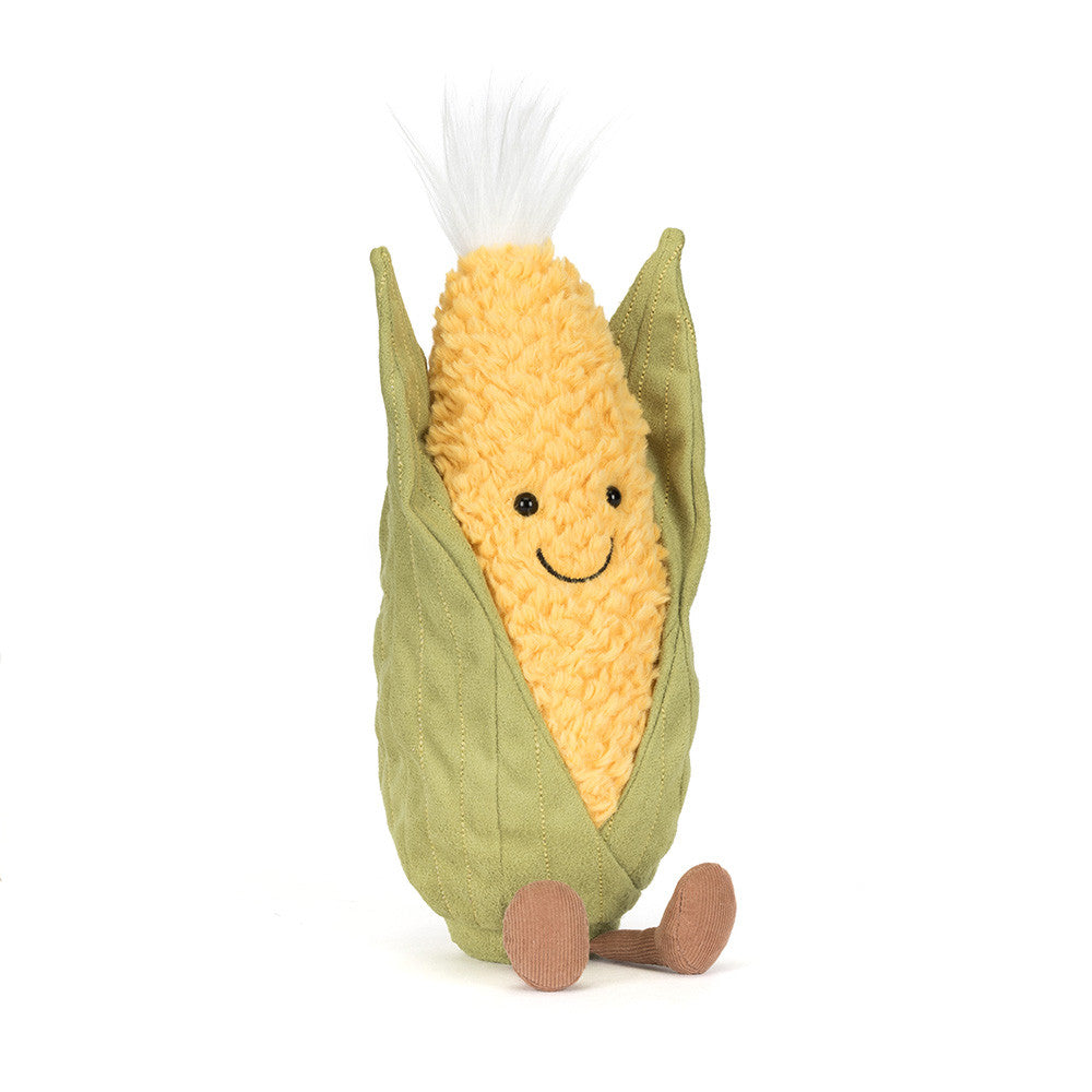 Plush toy corn on the cob with a smiling face on a white background