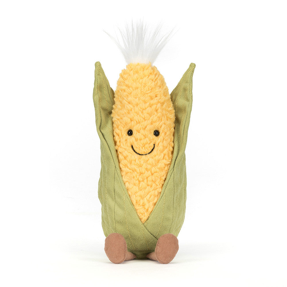 Plush toy corn on the cob with a smiling face on a white background