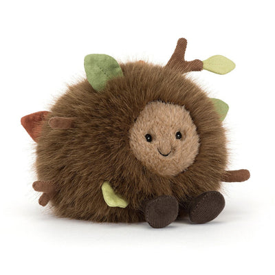 jellycat forest floor with fuzzy fur and leaves and sticks and cute face and legs on white background
