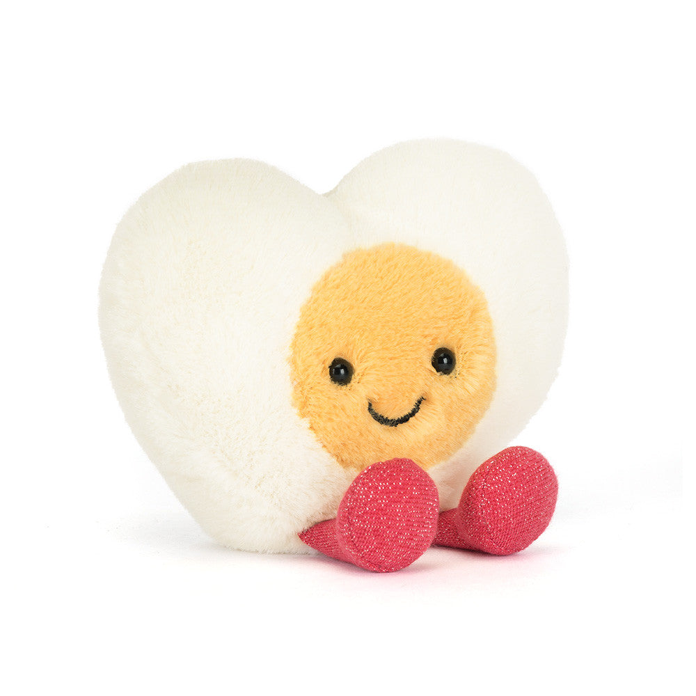 Heart-shaped boiled egg plush toy with a smiling face on a white background