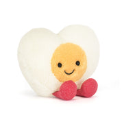 Heart-shaped boiled egg plush toy with a smiling face on a white background