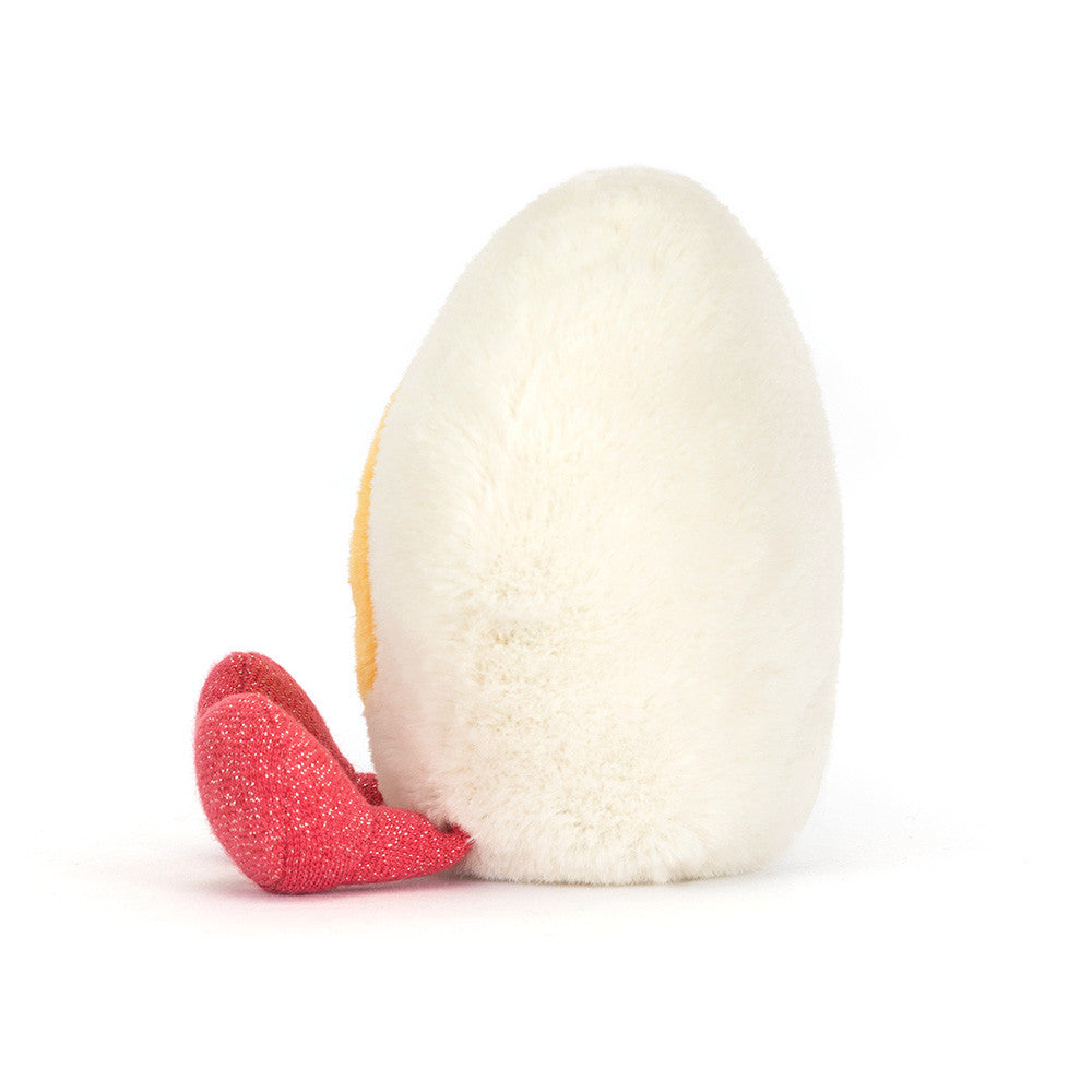 side view of heart shape boiled egg plush toy on white background