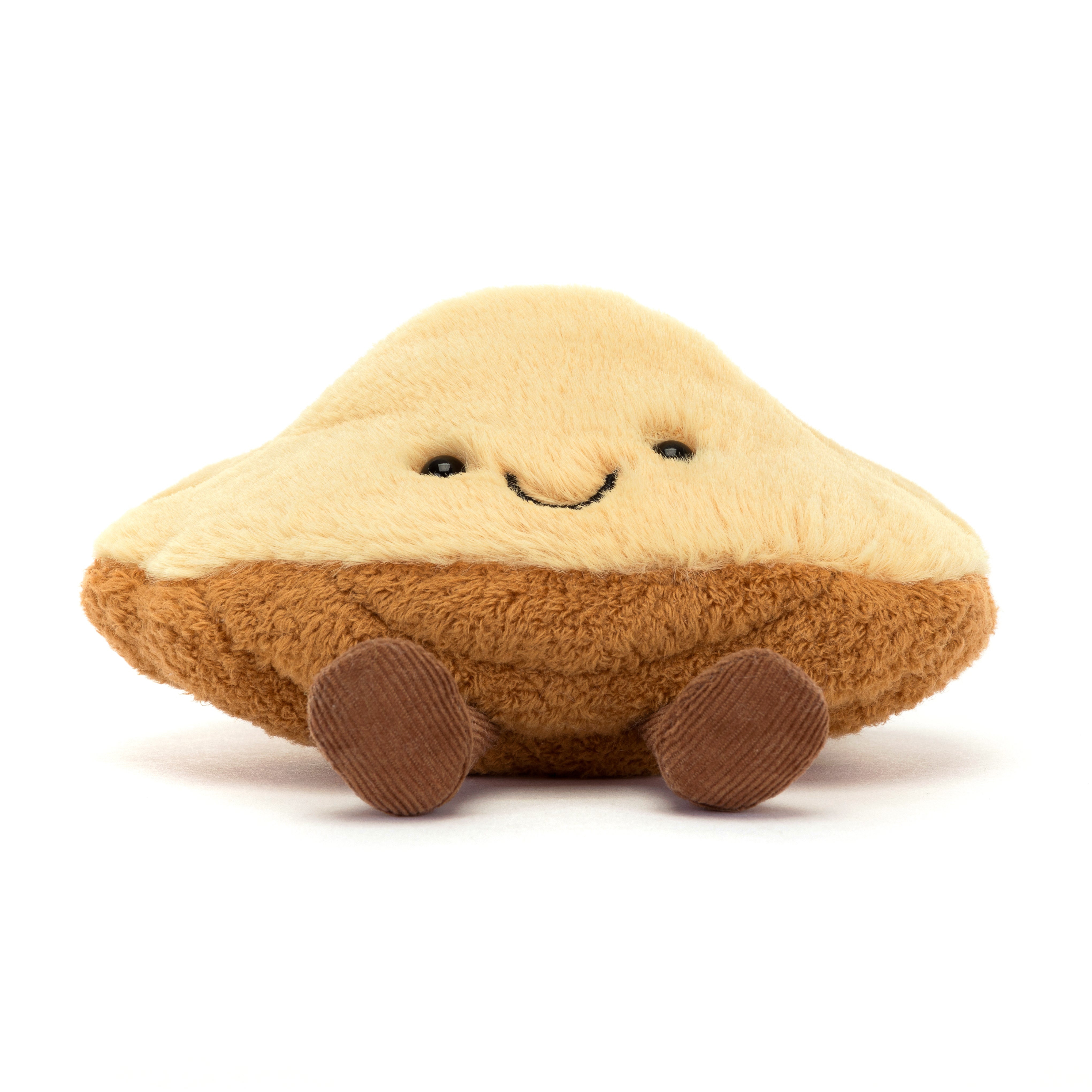 smiling plush madeleine pastry toy on white background