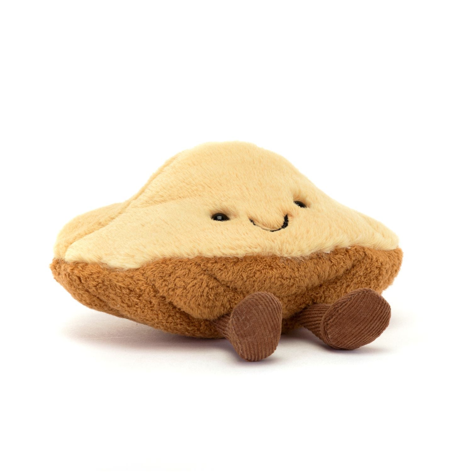 smiling plush madeleine pastry toy on white background
