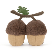 back view of Two jellycat plush acorns with faces and a branch on a white background