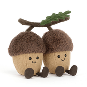 Two jellycat plush acorns with faces and a branch on a white background