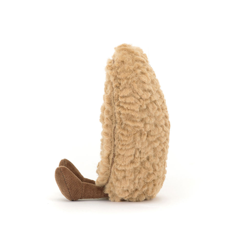 side view of beige plush toy with brown feet on a white background