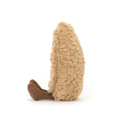 side view of beige plush toy with brown feet on a white background