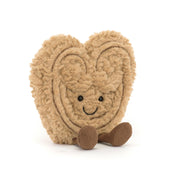 Heart-shaped cookie plush toy with a smiling face on a white background