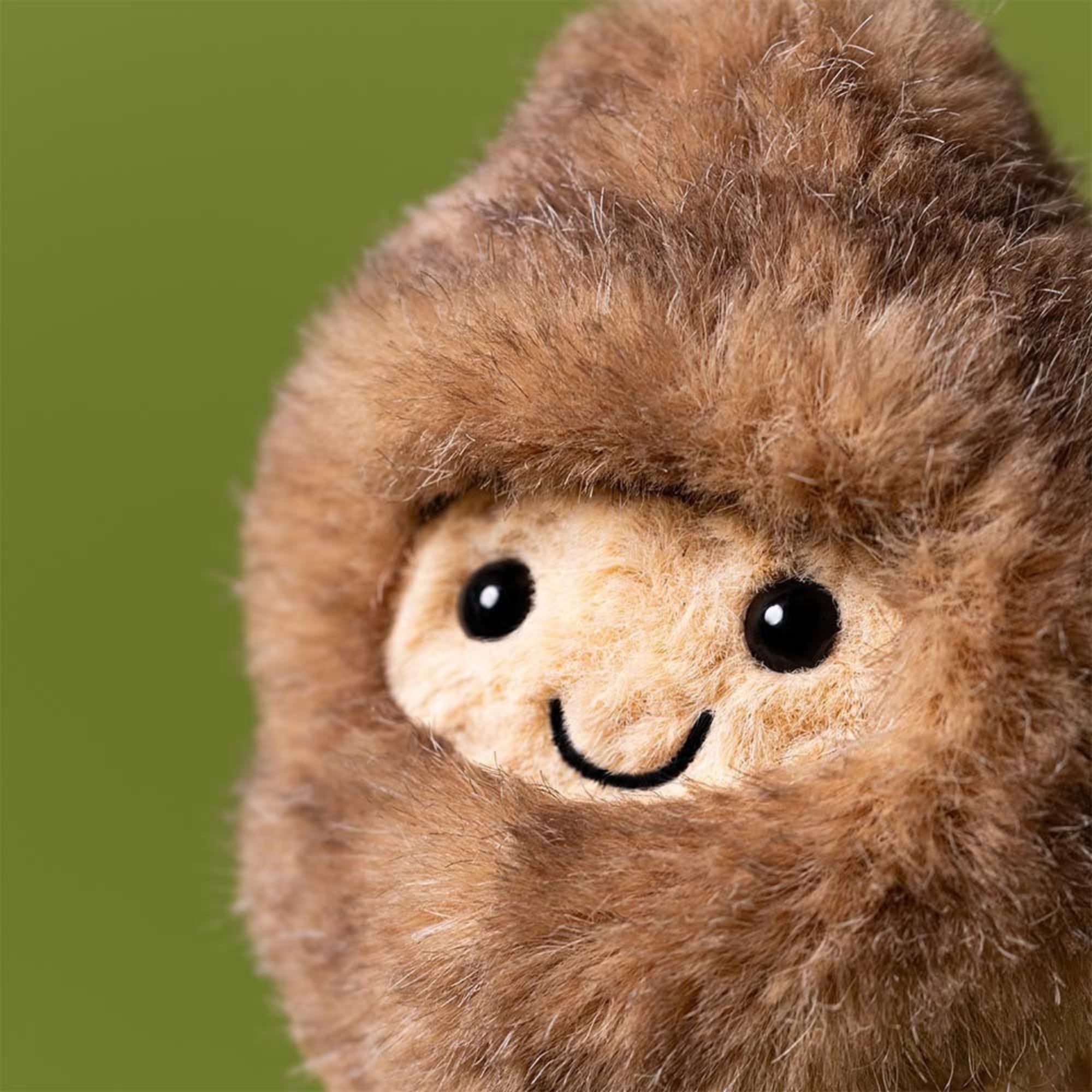 close up of Jellycat peanut dressed as a Yeti on green background
