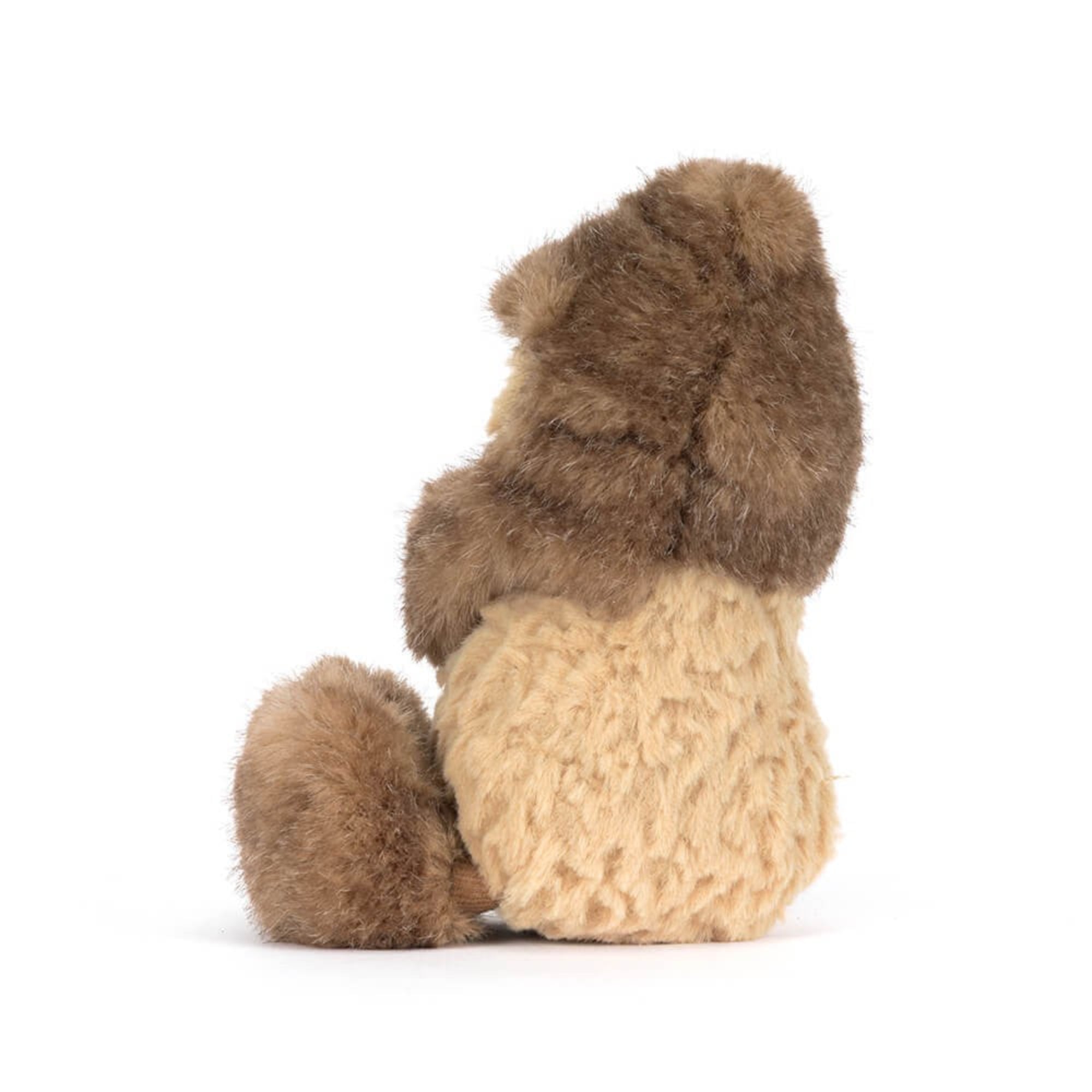 side view of Jellycat peanut dressed as a Yeti on white background
