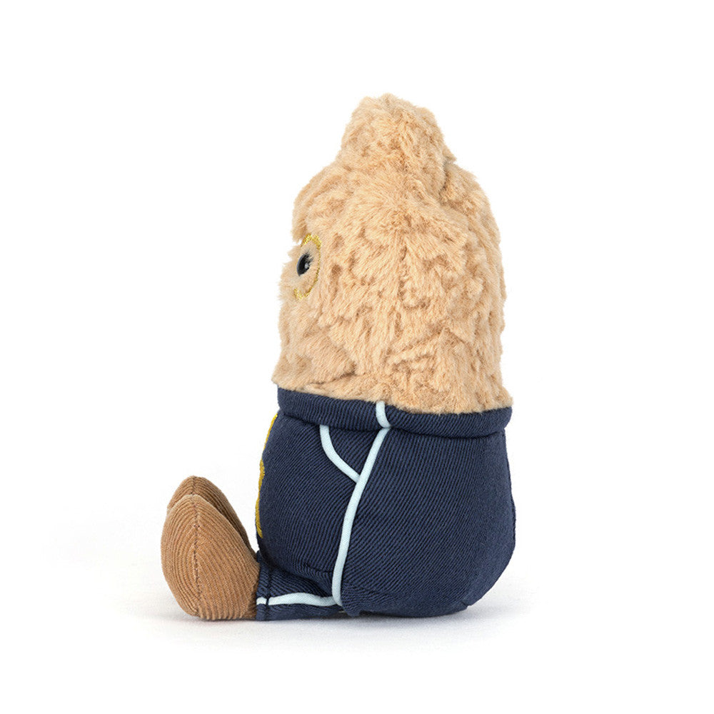 Small plush toy with a navy outfit on a white background