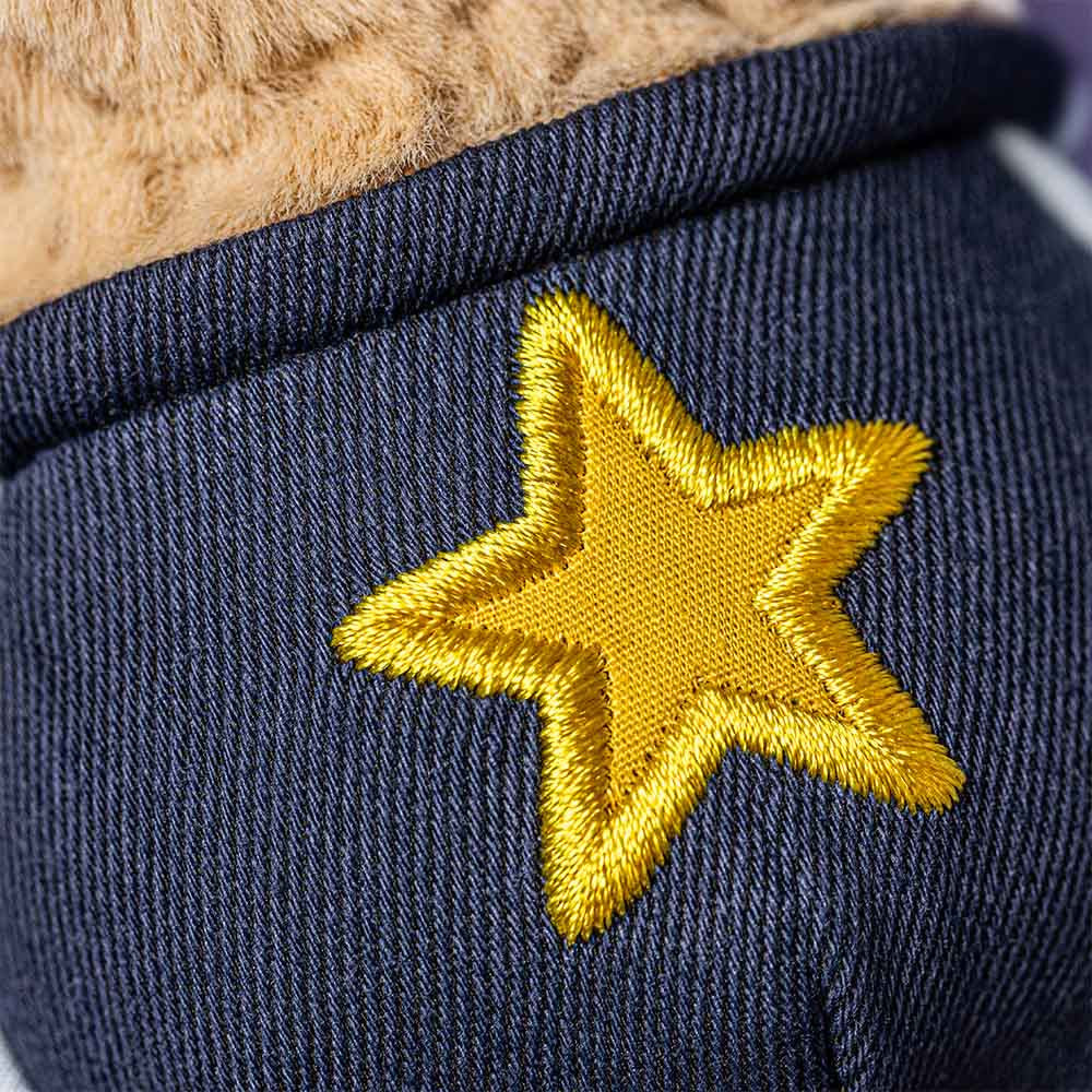 Navy blue fabric with a yellow embroidered star