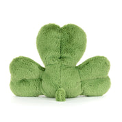 Green plush toy shaped like a clover on a white background