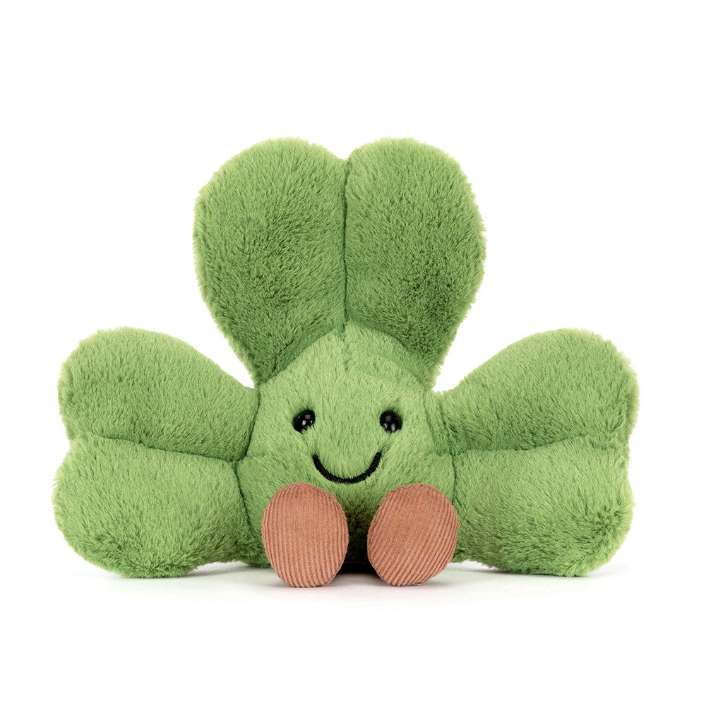 green plush toy shamrock with smiling face on white background