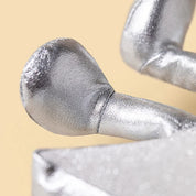 close up of A silver glittery star-shaped jellycat brand plush toy with a smiling embroidered face and small feet