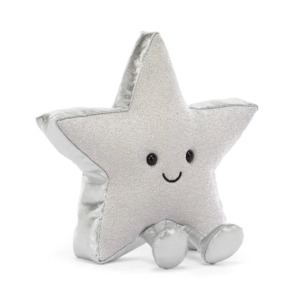 A silver glittery star-shaped jellycat brand plush toy with a smiling embroidered face and small feet, photographed on a clean white background.