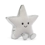 A silver glittery star-shaped jellycat brand plush toy with a smiling embroidered face and small feet, photographed on a clean white background.