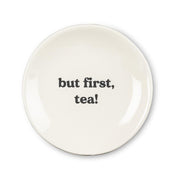 small white dish with bold black writing that says "but first, tea!" on white background